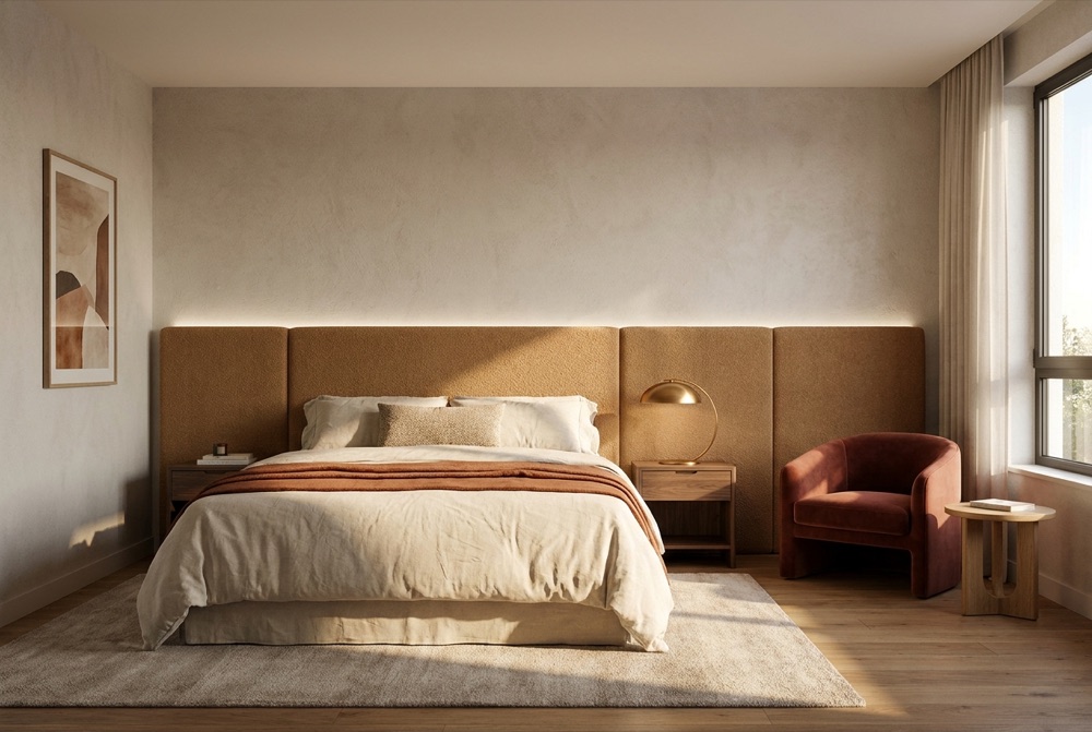 Comfort-Zimmer mit gepolstertem Kopfteil, warmen Textilien und Loungesessel